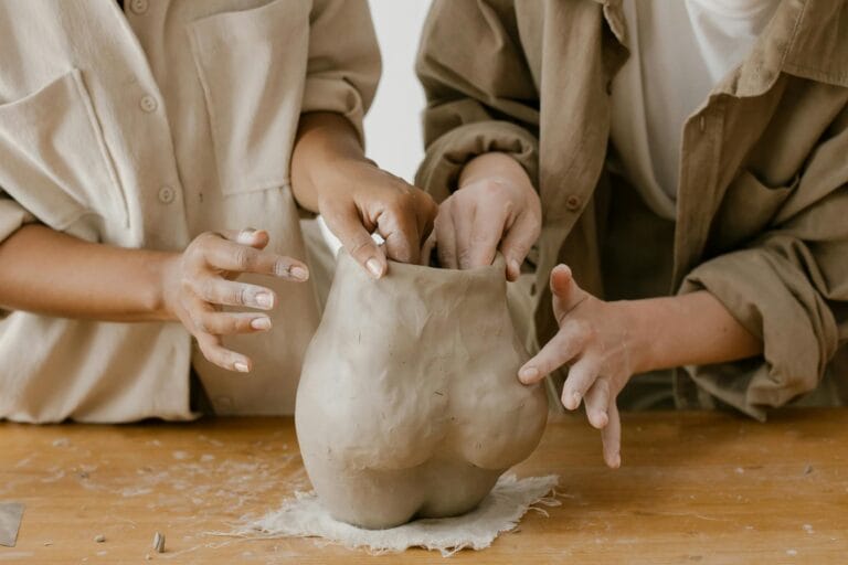 people molding a clay