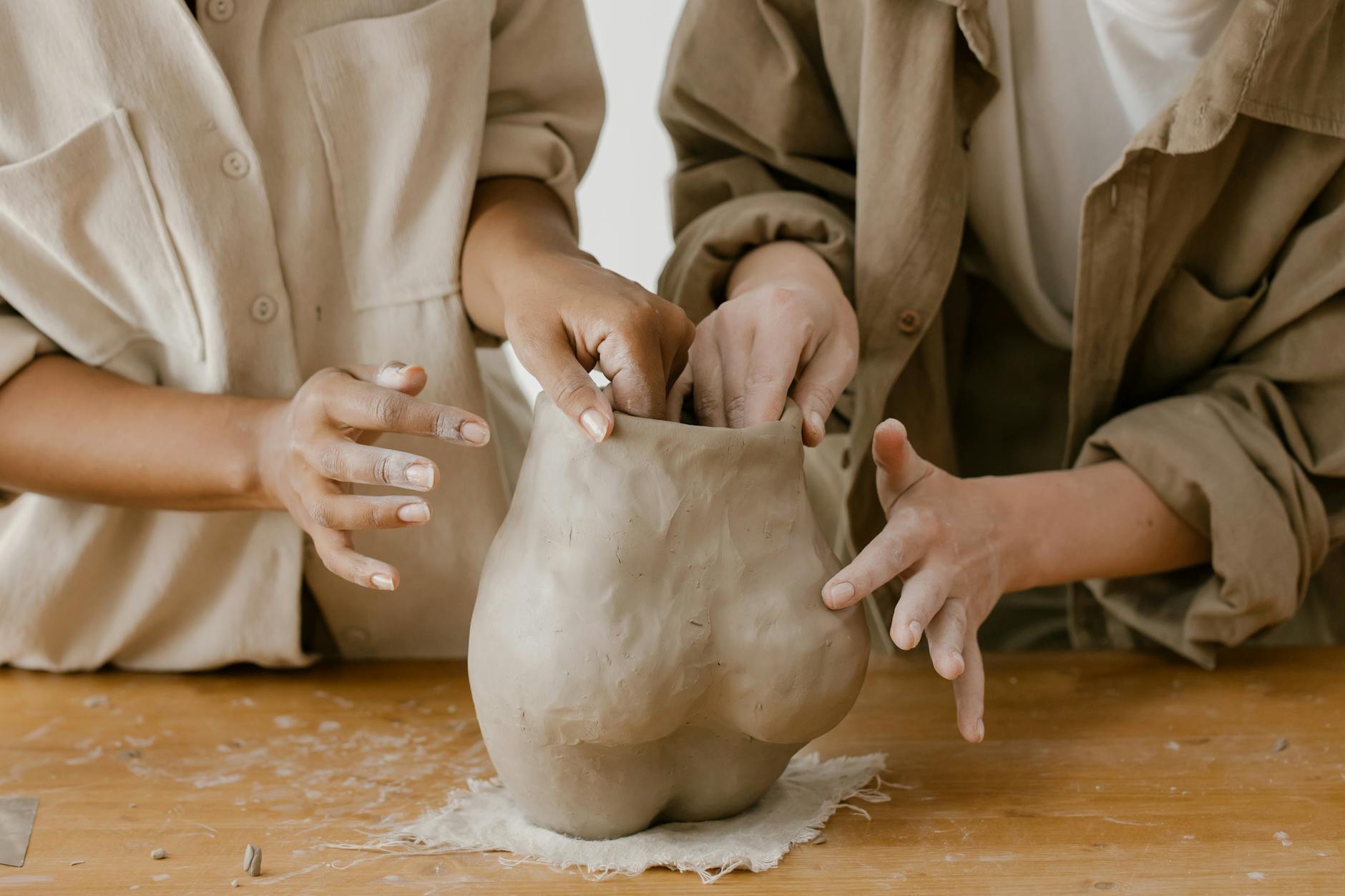 people molding a clay